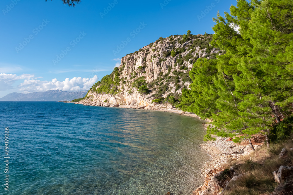 Scenic view of idyllic hiking trail along majestic cliffs between coastal villages Krvavica and Makarska, Dalmatia, South Croatia, Europe. Majestic Makarska Riviera, Adriatic Mediterranean Sea. Summer