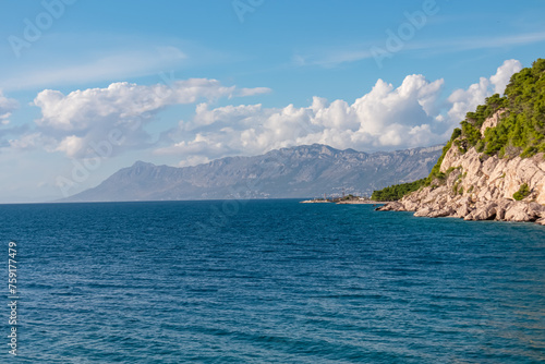 Scenic view of idyllic hiking trail along majestic cliffs between coastal villages Krvavica and Makarska, Dalmatia, South Croatia, Europe. Majestic Makarska Riviera, Adriatic Mediterranean Sea. Summer photo