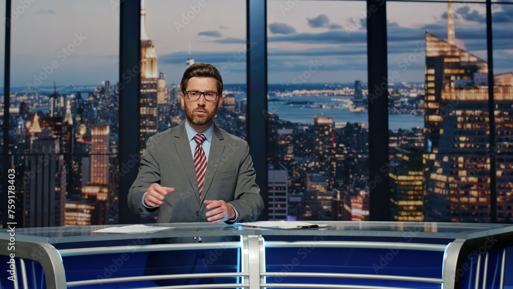 © stockbusters - Serious anchor reporting events at newsroom. Presenter speaking at news desk © stockbusters - Serious anchor reporting events at newsroom. Presenter speaking at news desk