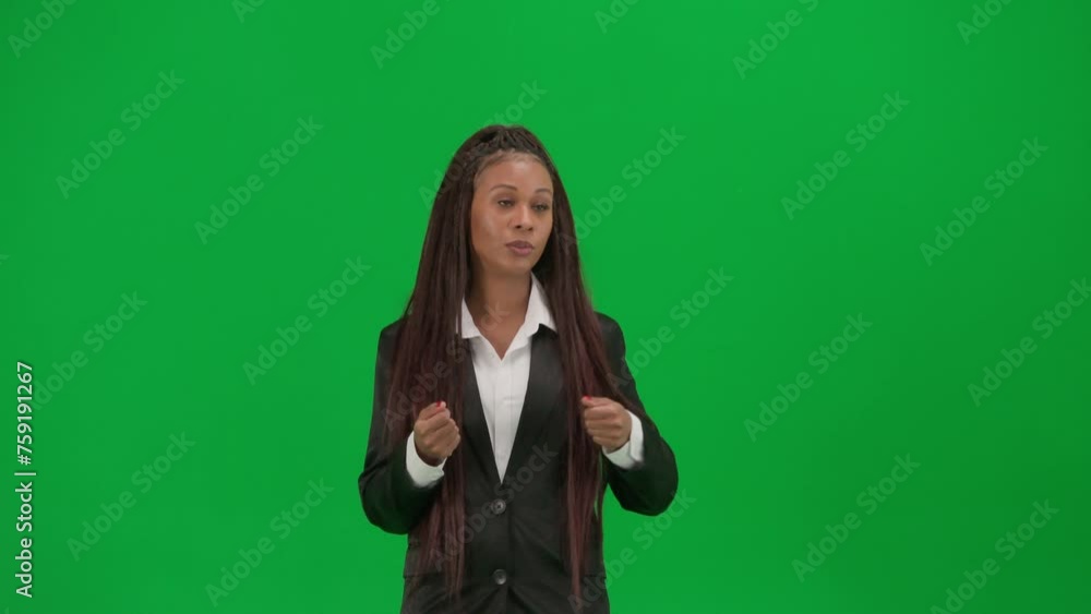 Female reporter isolated on chroma key green screen background. African American woman news host in suit telling the news. Female reporter isolated on chroma key green screen background. African American woman news host in suit telling the news.