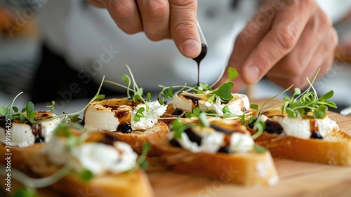 chef expertly coating crispy crostini with a drizzle of balsamic glaze and microgreens