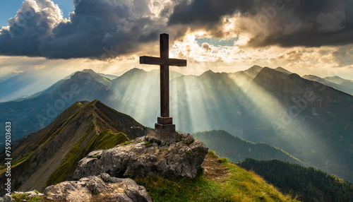 Divine Light: Cross on Mountain Peak Bathed in Sunrays, Easter Sunday, Sacrifice, redemption, salvation, eternal life photo