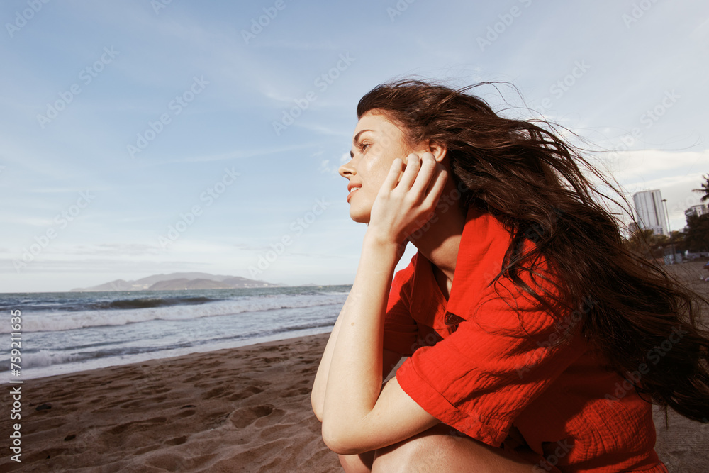Carefree Beauty: A Portrait of a Happy Woman Enjoying a Summer Vacation on the Beach, Embracing Freedom and Relaxation under the Sunset Sky and by the Sparkling Ocean
