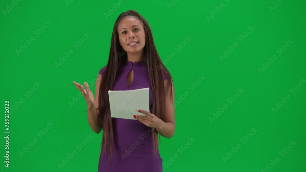 Female reporter isolated on chroma key green screen background. African American woman news host in dress reading from papers and talks. Female reporter isolated on chroma key green screen background. African American woman news host in dress reading from papers and talks.