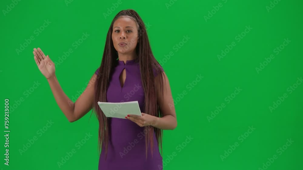 Female reporter isolated on chroma key green screen background. African American woman news host in dress reading from papers and talks. Female reporter isolated on chroma key green screen background. African American woman news host in dress reading from papers and talks.