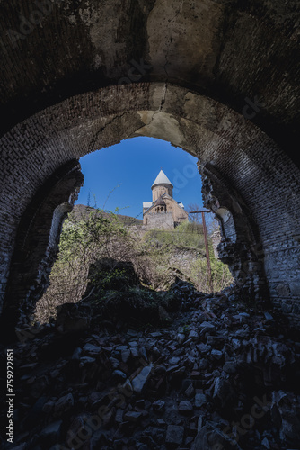 Ruins of small chapel next to Ananuri Castle over the Aragvi River in Dusheti Municipality, Georgia photo