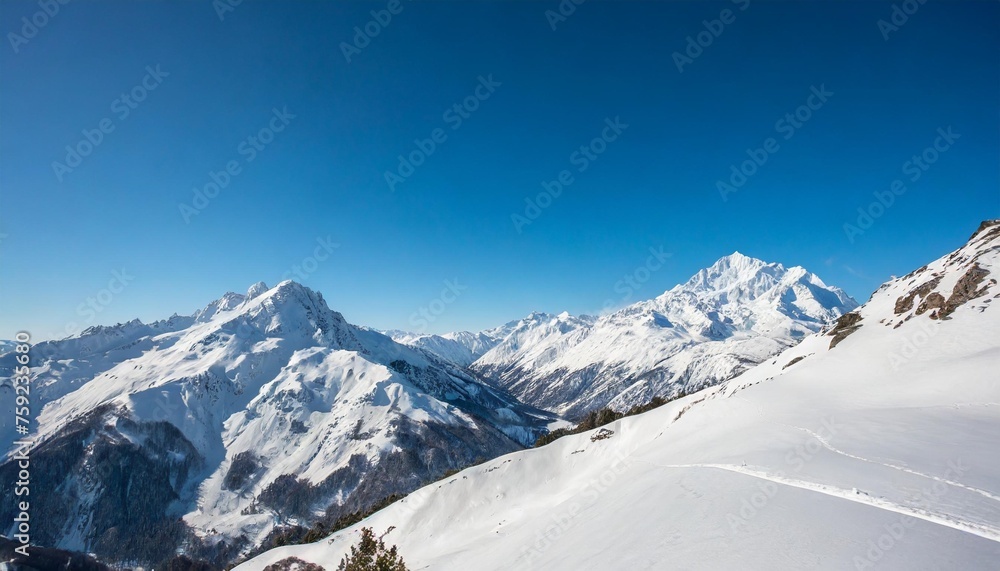 wide angle view landscape of white snowy mountains range with clear blue sky during cold winter nature concept for extreme lifestyle product background
