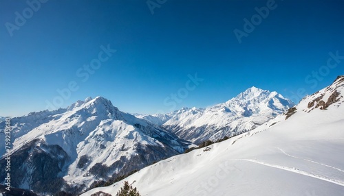 wide angle view landscape of white snowy mountains range with clear blue sky during cold winter nature concept for extreme lifestyle product background