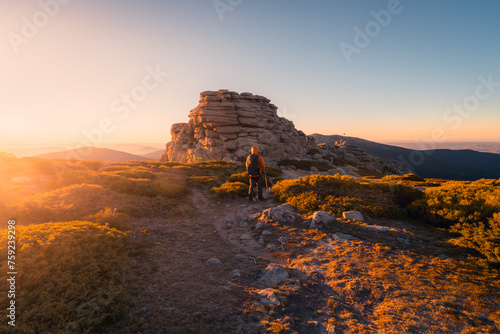Hiker viewing sunset from Siete Picos in Sierra de Guadarrama photo