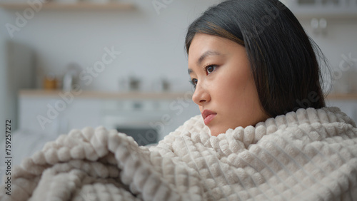 Tableau sur toile Close up sad depressed Asian chinese woman alone at home covered in blanket thou