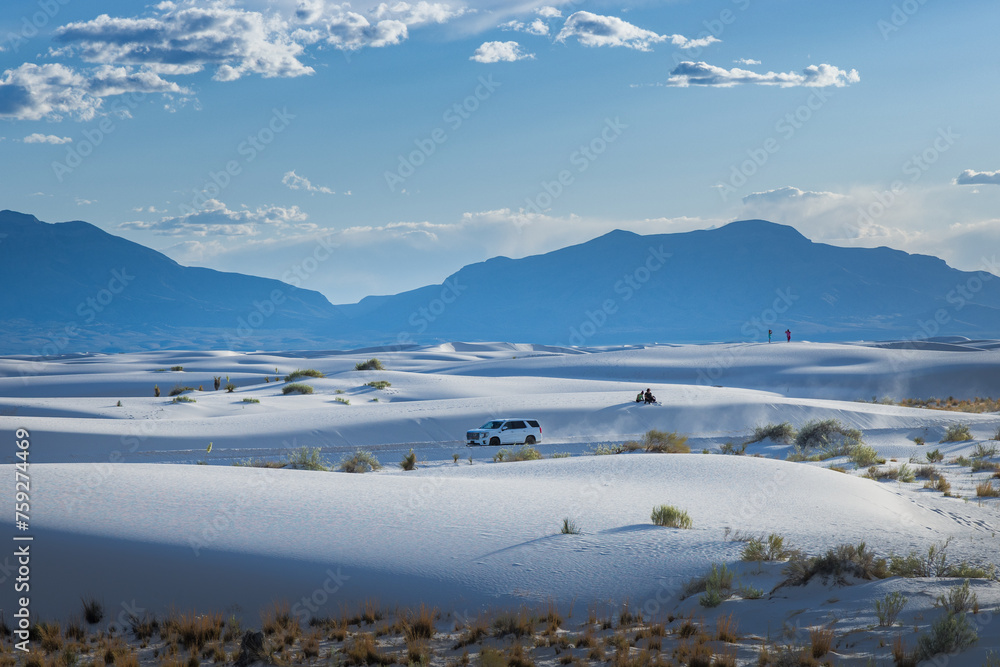 Car blowing dust in the deserts of White Sands National Park, New Mexico