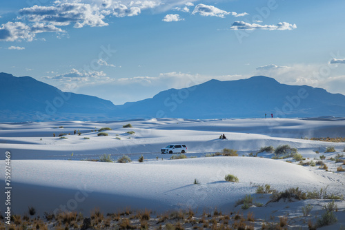 Car blowing dust in the deserts of White Sands National Park, New Mexico photo