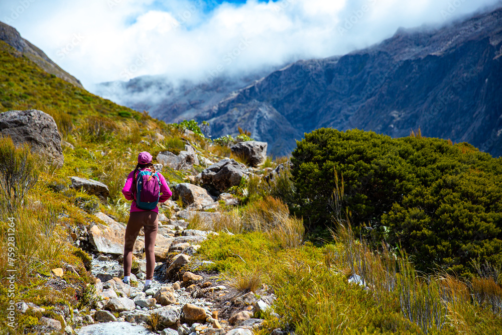 hiker girl enjoys a scenic path in southern alps - otira valley track in canterbury, new zealand south island, arthur's pass national park hiker girl enjoys a scenic path in southern alps - otira valley track in canterbury, new zealand south island, arthur's pass national park