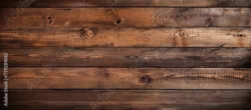 A detailed shot of a brown hardwood plank wall with a blurred background, showcasing the natural beauty of the wood grain and pattern