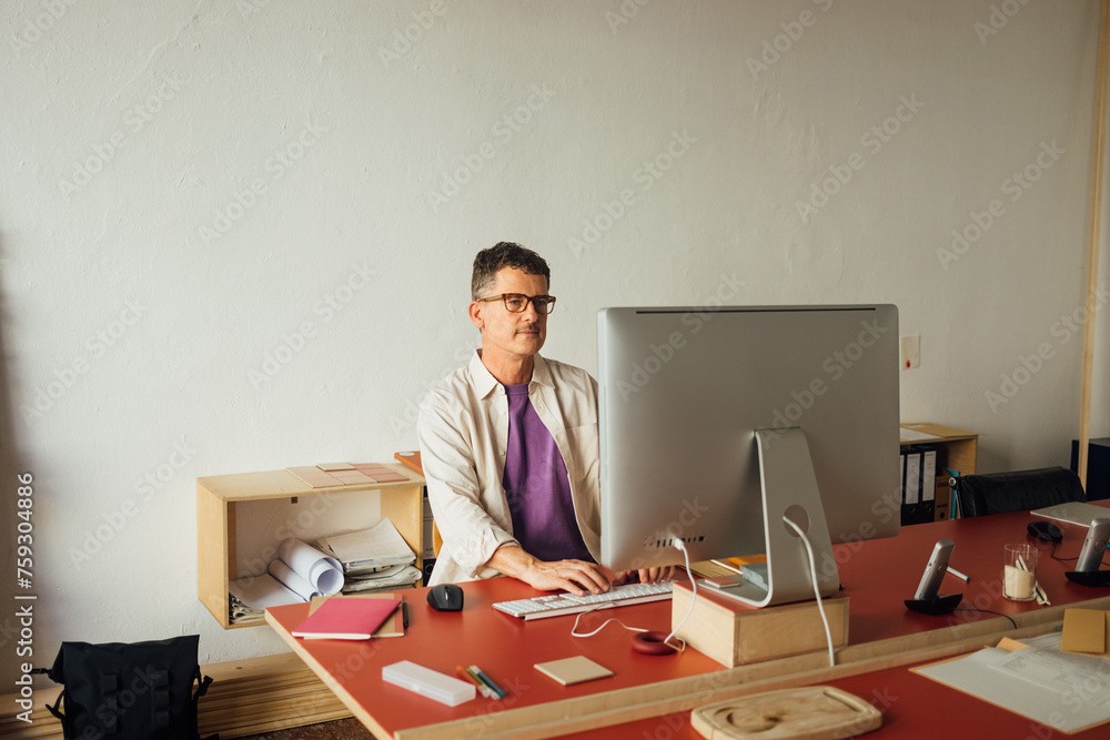 Man typing on keyboard in office Man typing on keyboard in office