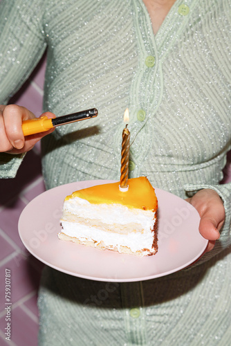 Crop woman lighting candle on piece of birthday cake