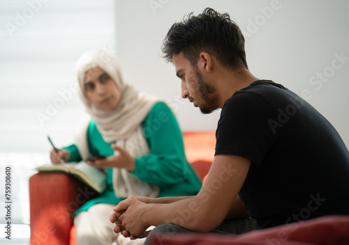 Muslim Therapist Using Smart App during Therapy Session photo