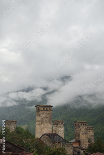 Misty Urban Architecture: Ancient Towers in Foggy Weather photo