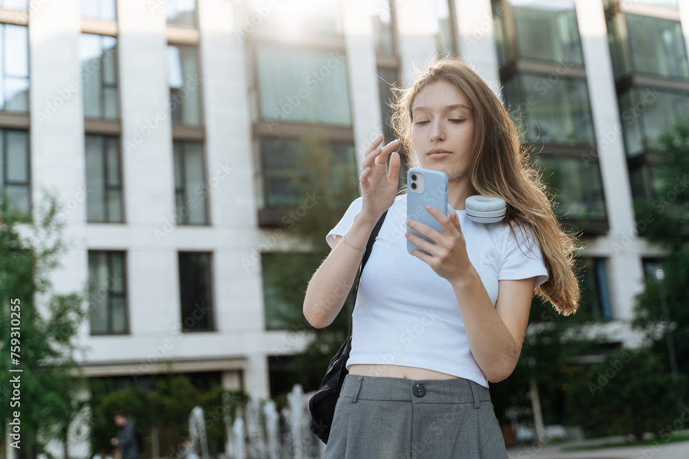 Young student girl with phone and wireless headphones Young student girl with phone and wireless headphones