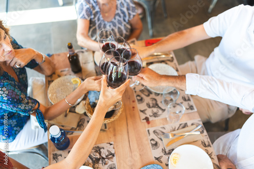 happy family toasting with wine at mealtime photo