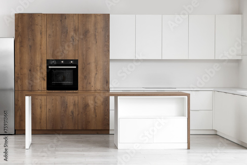 Interior of empty kitchen with table and counters