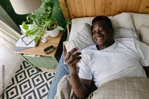 A man with a phone in the morning photo