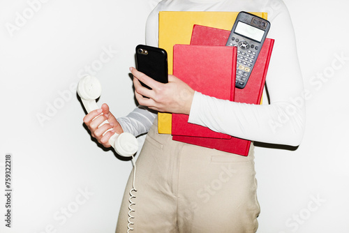 Bosslady holding landline, smartphone, calculator &  phone with flash