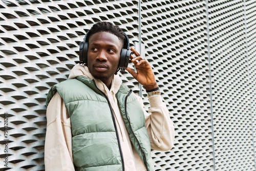 Black man putting on headphones photo