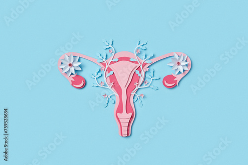 Top view of female uterus with blossoms made of colorful paper