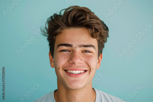 A young man with acne on his face smiles for the camera