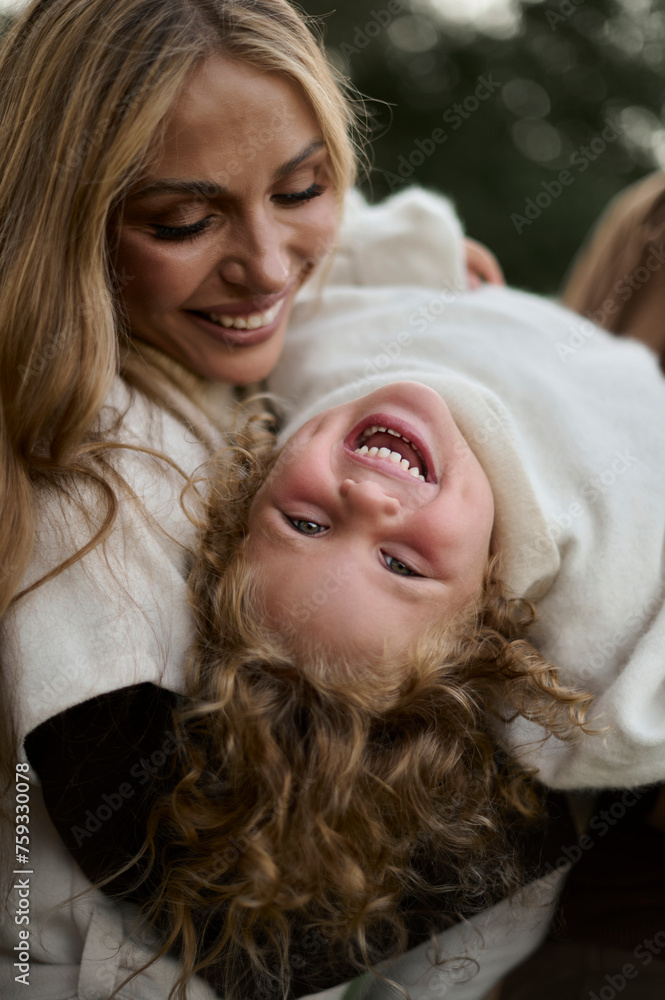 mother playing with her curly child mother playing with her curly child
