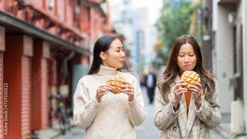 Photography Happy Asian woman eating Japanese sweet bread during travel at Asakusa district, Tokyo, Japan
