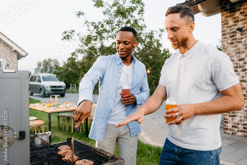 Two men barbecue