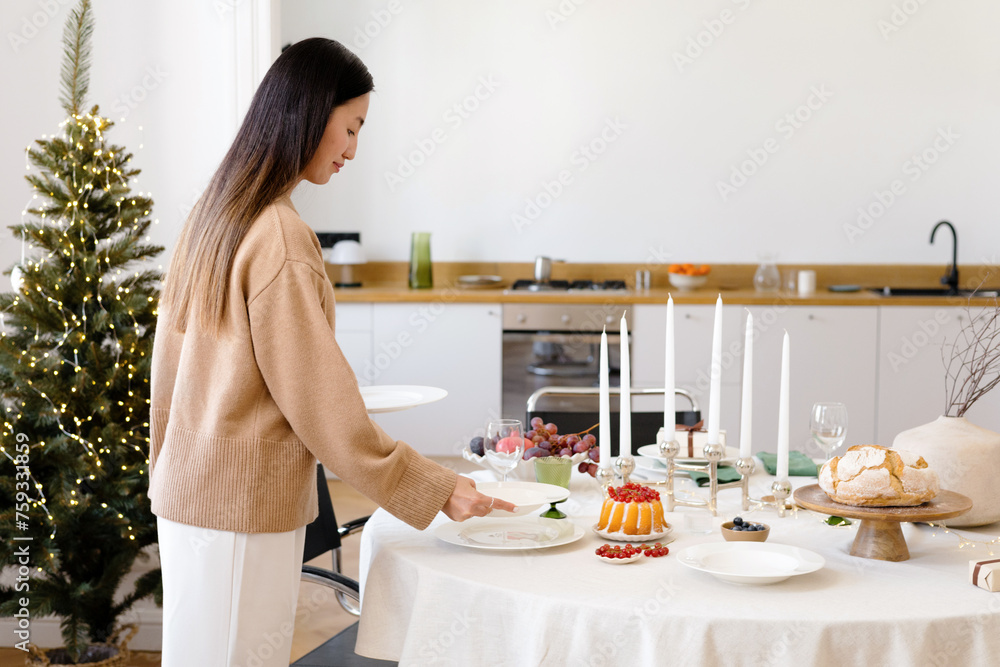 Christmas Table Setting: Woman Creating Holiday Magic Christmas Table Setting: Woman Creating Holiday Magic