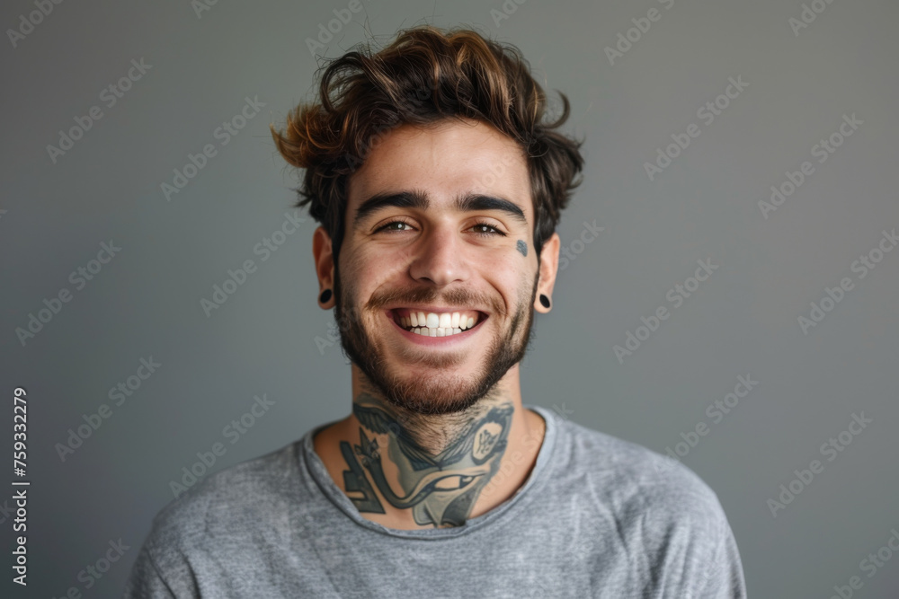 A man with a tattoo on his neck is smiling A man with a tattoo on his neck is smiling