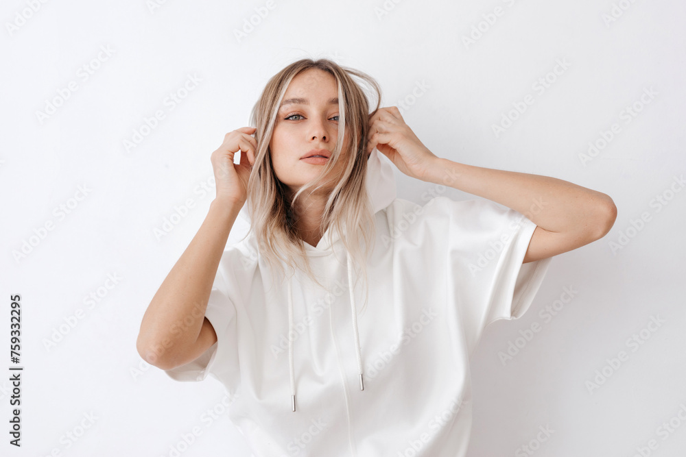 Trendy young woman wearing white hooded jacket Trendy young woman wearing white hooded jacket