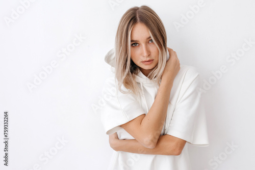 Charming woman with blond hair in white outfit photo