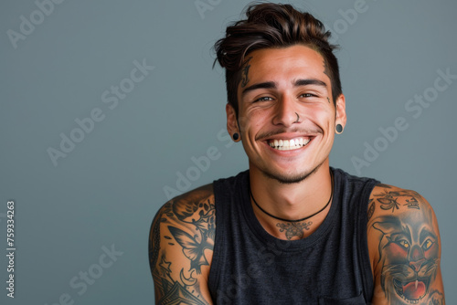 A man with a lot of tattoos on his arms is smiling