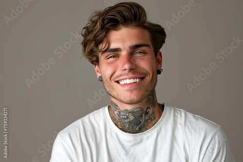 A man with a tattoo on his neck is smiling