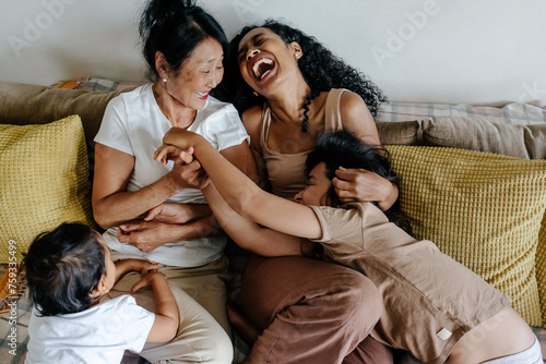 Family playing on couch at home