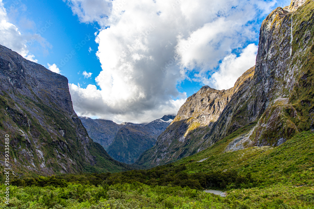 Fototapeta premium unique stunning landscape of Milford Sound - fjord and tall waterfalls flowing down the wall of a mighty mountain in Fiordland National Park, Southland, New Zealand
