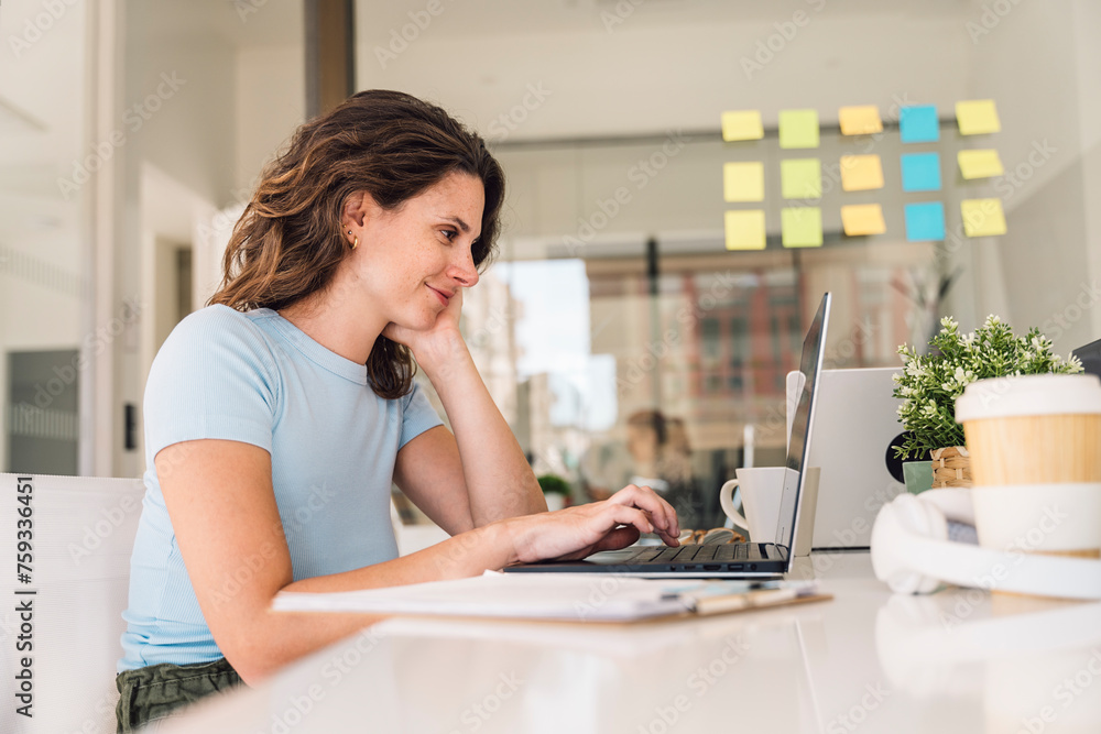 Businesswoman using laptop in office Businesswoman using laptop in office