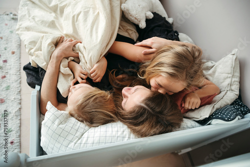 Loving family together on bed together. photo