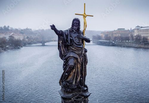 Statue of St. John the Baptist in snow photo