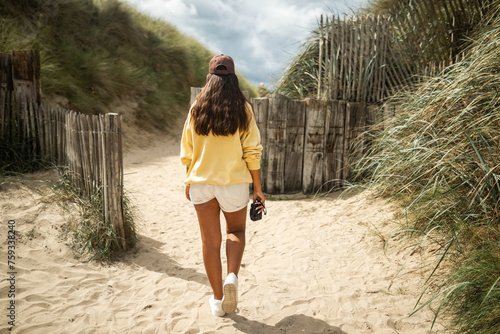 woman walking on the beach photo