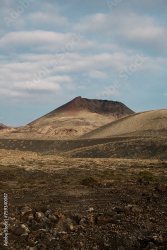 A volcano's crater is visible in the far-off horizon