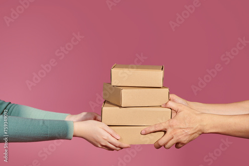 Woman keep a lot of cardboard boxes. Express delivery concept. photo