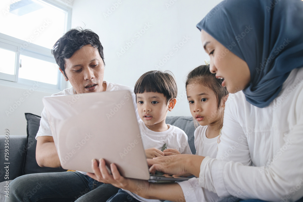 Parents Teaching Kids Using Laptop. Fun Learning at Home. Parents Teaching Kids Using Laptop. Fun Learning at Home.