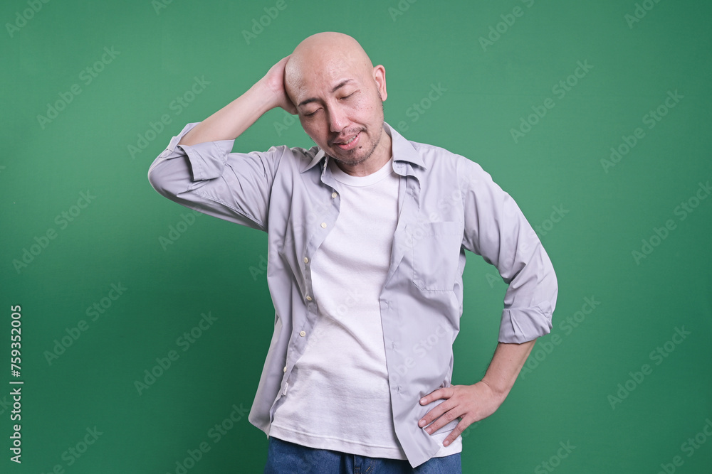 Fototapeta premium Funny Man Forget and Doing Mistakes, Feel Wrong, Standing Isolated on Green Background.