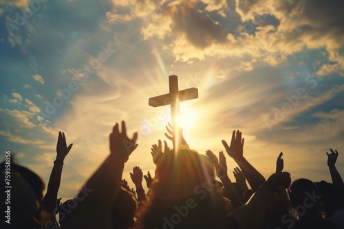 Christians who pray to God and devoutly raise their hands towards the cross photo
